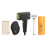 Nood Noodist Pro Kit in black including Buff Bar, black Eraser, Flasher Pro IPL device in black with gold accents, white razor, and Nood Serum daily aftercare on black background