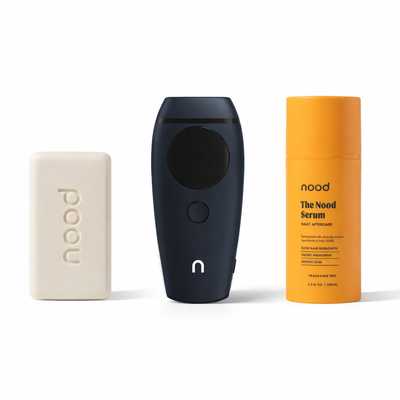 Nood Flasher 2.0 Kit in navy blue including Buff Bar soap, Flasher 2.0 IPL device in navy, and Nood Serum daily aftercare on white background