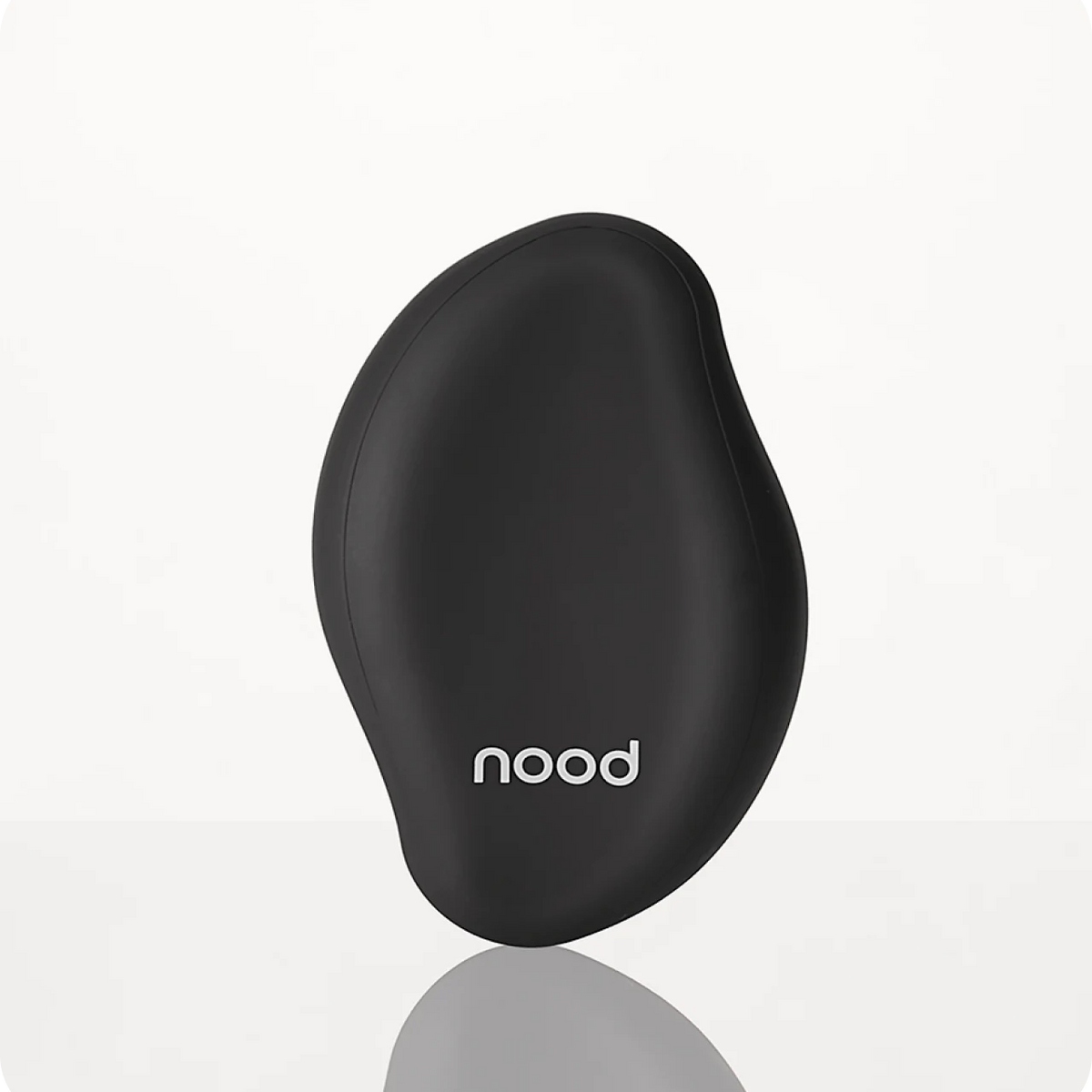 Nood The Eraser IPL hair removal device in black on a light grey background with reflection